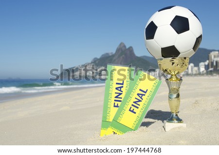 Pair of final tickets with trophy and football on the beach