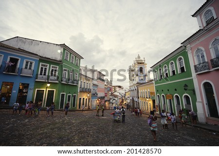 SALVADOR, BRAZIL - OCTOBER 12, 2013: Tourists and locals mix in a plaza as dusk falls over the historic city center of Pelourinho.