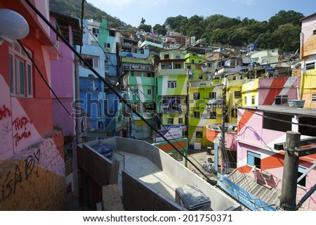 RIO DE JANEIRO, BRAZIL - FEBRUARY 14, 2014: Graffiti decorates the colorful painted buildings at the entrance to the Favela Santa Marta community.