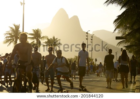 RIO DE JANEIRO, BRAZIL - FEBRUARY 02, 2014: Active Brazilians walk skate and bike along Avenida Vieira Souto in Ipanema, a leisure hotspot for city residents.