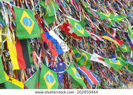 Brazilian and international flags flying on a wall of wish ribbons Church Igrega Nosso Senhor do Bonfim Salvador Bahia Brazil