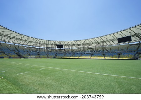 RIO DE JANEIRO, BRAZIL - JANUARY 29, 2014: Empty field-level view of Maracana football soccer stadium grandstand under bright blue sky.