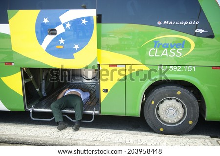 RIO DE JANEIRO, BRAZIL - OCTOBER 19, 2013: Brazilian bus driver takes a nap inside the luggage hold of his vehicle parked at Copacabana Beach.