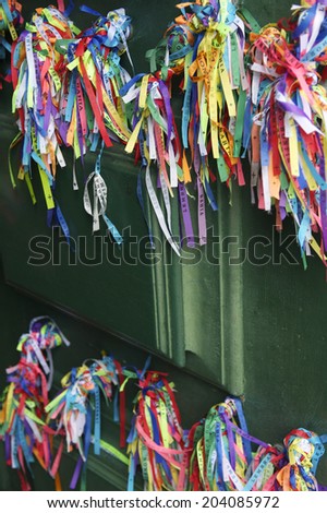 Colorful Brazilian wish ribbons decorate a green door at the Bonfim Church Salvador Bahia Brazil