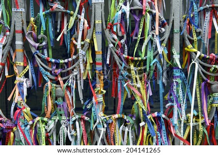 Colorful Brazilian wish ribbons hanging from decorative iron fence at the Bonfim Church Salvador Bahia Brazil
