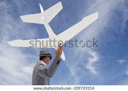 Entrepreneur businessman flying white model airplane against blue sky