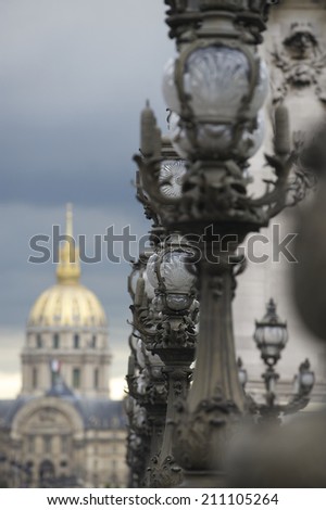 Paris France architecture Dome des Invalides with decorative wrought iron lamp posts in the foreground