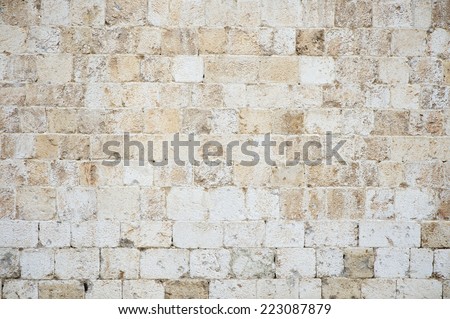 Old textured stone wall background in textured white Istrian marble on the Stradun in Dubrovnik Croatia