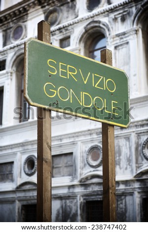 Venice Italy sign advertising Servicio Gondole (Gondola Service) with traditional Venetian architecture