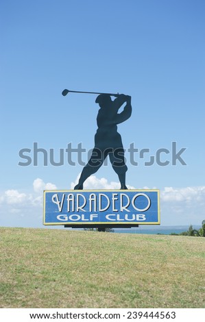 VARADERO, CUBA - MAY 25, 2011: Silhouette of golfer stands atop a sign for the Varadero Golf Club.