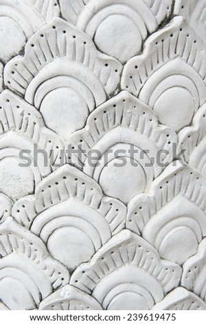 Stylized white decorative background pattern of dragon scales at the entrance to a Buddhist temple in Chiang Mai Thailand
