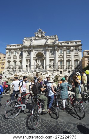 ROME, ITALY - CIRCA MAY, 2012: A group of tourists on bicycles join the sightseeing crowds at the famous Trevi Fountain.