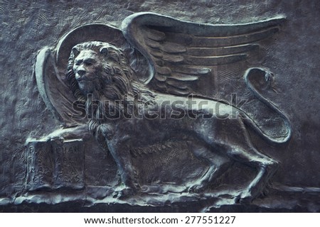Ancient wall relief of the winged Lion of Saint Mark, the patron saint symbol of Venice Italy