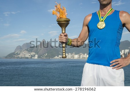 Brazilian gold medal athlete standing with sport torch above Rio de Janeiro Brazil skyline at Ipanema Beach