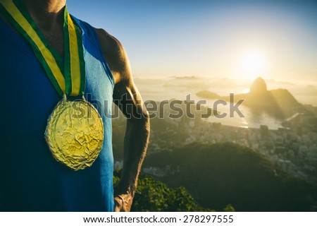 Gold medal champion athlete standing outdoors at the golden sunrise at Rio de Janeiro skyline