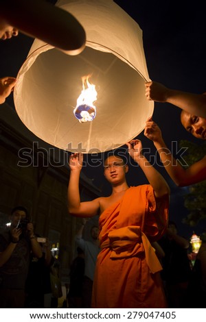 CHIANG MAI, THAILAND - NOVEMBER 07, 2014: Group of Buddhist monks launch sky lanterns at the annual Yee Peng festival of lights at Wat Pan Tao Temple.
