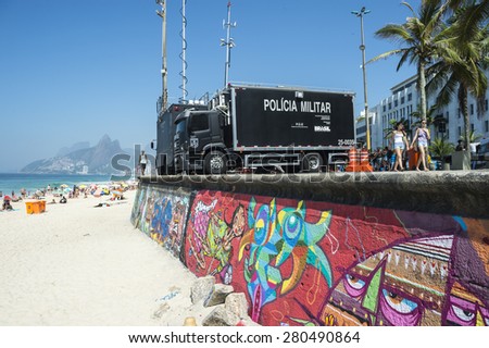 RIO DE JANEIRO, BRAZIL - JANUARY 20, 2015: Imposing police surveillance trucks set up as a command center to stand guard at the Arpoador lookout in preparation for a busy summer day on Ipanema Beach.