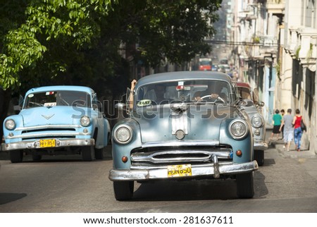 HAVANA, CUBA - CIRCA JUNE, 2011: Vintage American taxi cars share the road in Central Havana.