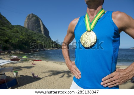 First place athlete wearing gold medal standing outdoors in front of Sugarloaf Mountain Rio de Janeiro Brazil