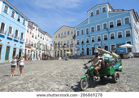 SALVADOR, BRAZIL - MARCH 12, 2015: Motorcart pulling garbage drives along the cobblestone hill in the historic city center of Pelourinho.