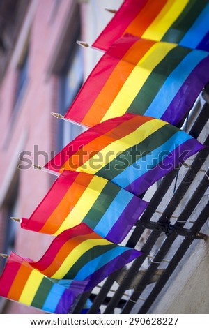 Gay pride rainbow flags hanging from traditional New York City fire escape on Christopher Street