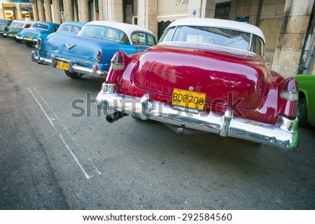 HAVANA, CUBA - JUNE, 2011: Row of colorful classic American cars stand parallel parked on the famous Paseo del Prado avenue in Central Havana.