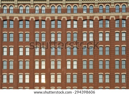 Traditional brick architecture skyscraper with arched window details full frame background