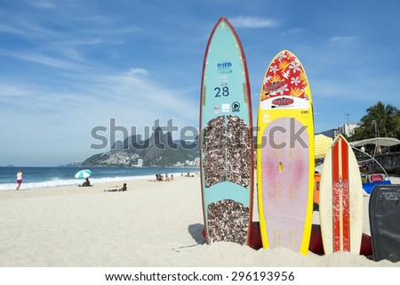 RIO DE JANEIRO, BRAZIL - MARCH 22, 2015: Colorful stand up paddle surfboards stand lined up on the beach at Arpoador.
