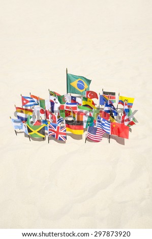 Brazilian flag surrounded by international flags flying on smooth sand beach in Rio de Janeiro Brazil