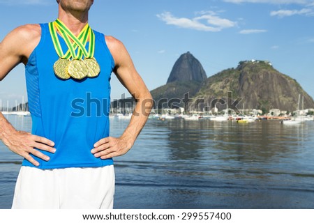 Frst place athlete with three gold medals standing outdoors at Botafogo Bay Rio de Janeiro Brazil