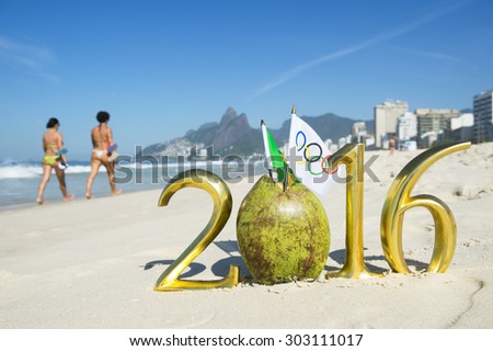 RIO DE JANEIRO, BRAZIL - FEBRUARY 12, 2015: Illustrative editorial of Olympic and Brazilian flags fly in coconut making a gold medal 2016 message on Ipanema Beach.