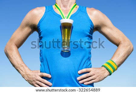 Octoberfest athlete standing with first place gold medal in the shape of a glass of beer standing in front of blue sky