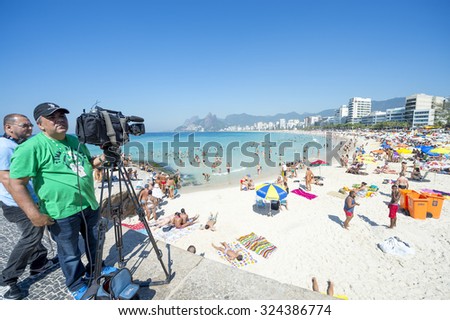 RIO DE JANEIRO, BRAZIL - FEBRUARY 08, 2015: Video crew set up to film in front of a bright morning beach scene at Arpoador, in Ipanema.