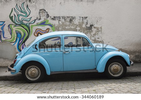RIO DE JANEIRO, BRAZIL - OCTOBER 22, 2015: Classic bright blue Volkswagen Type 1 Beetle, known locally as a Fusca, parked in colorful graffiti in the Santa Teresa neighborhood.