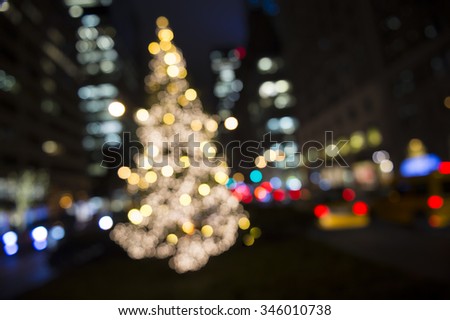Holiday Christmas tree in a defocused glowing scene from the center of Park Avenue in Midtown Manhattan, New York City