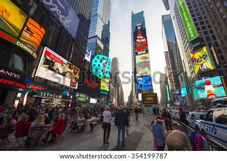 NEW YORK CITY, USA - DECEMBER 13, 2015: Bright signage flashes over holiday crowds as Times Square gets prepared for New Year\'s Eve celebrations.