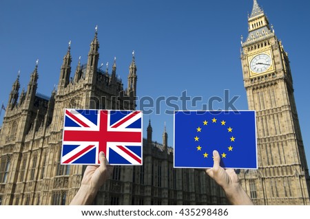 Hands holding European Union and British Union Jack flags in front of Big Ben and the Houses of Parliament at Westminster Palace, London, in preparation for the Brexit EU referendum