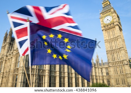 European Union and British Union Jack flag flying in motion blur in front of Big Ben and the Houses of Parliament at Westminster Palace, London, in preparation for the Brexit EU referendum