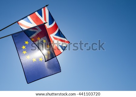 European Union and British Union Jack flag flying together in front of bright blue sky in preparation for the Brexit EU referendum