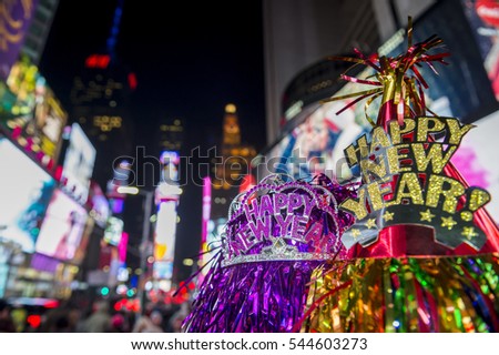 Happy New Year hats celebrating in the bright lights of Times Square, New York City