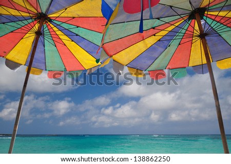 The twin umbrella with beautiful beach and clear sky