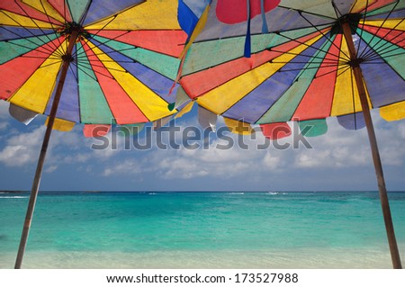 The twin umbrella with beautiful beach and clear sky