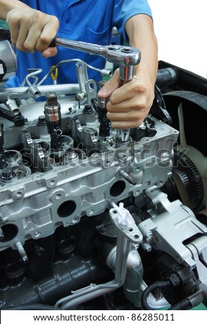 an automotive mechanic tightening using torque wrench