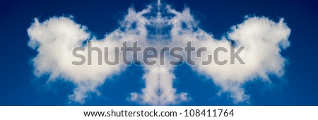 Figure from white clouds in blue sky