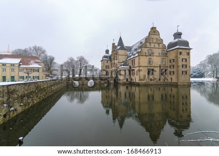 Dortmund / Germany - 21.03.2013: Panorama of castle on water covered with snow