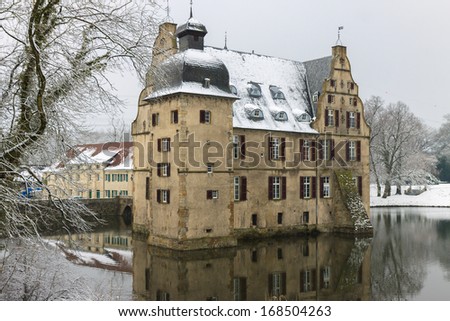 Dortmund, Germany -  March 21, 2013: Castle on water covered with snow