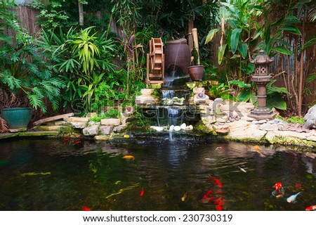 Natural decorative pond with fountain and gold fish