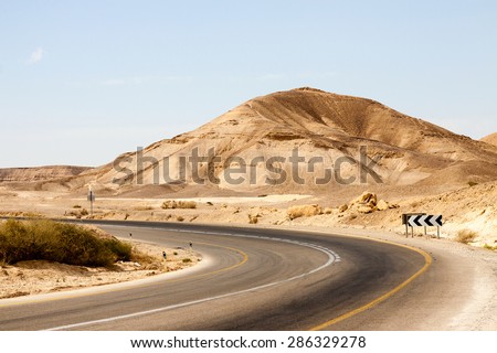 Big empty road with left turn in a mountains