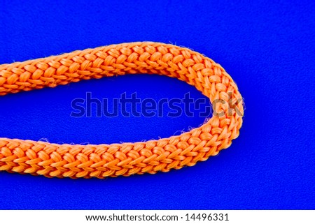 Part of orange rope isolated on blue background