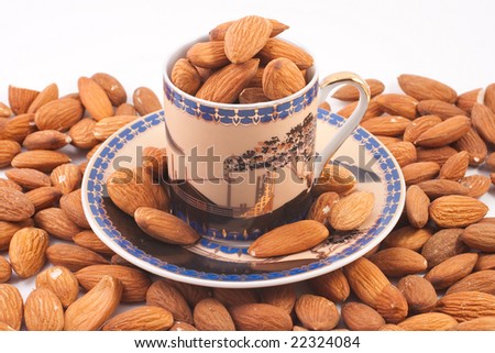 Coffee cup with almonds isolated on white background
